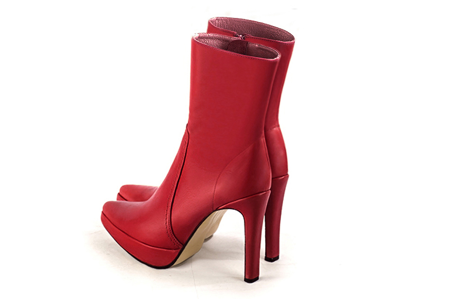 Scarlet red women's ankle boots with a zip on the inside. Tapered toe. Very high slim heel with a platform at the front. Rear view - Florence KOOIJMAN